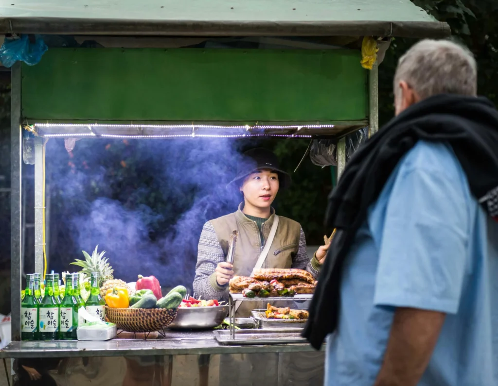 Vietnamese street vendor interacting with customer, offering fresh food and promoting sustainable practices.